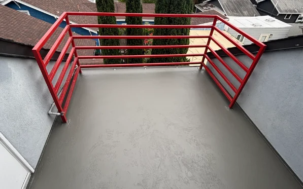 Finished deck after an SB 326 repair — new waterproof coating and repainted railings